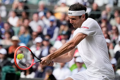 Taylor Fritz plays a backhand return to Lorenzo Musetti 